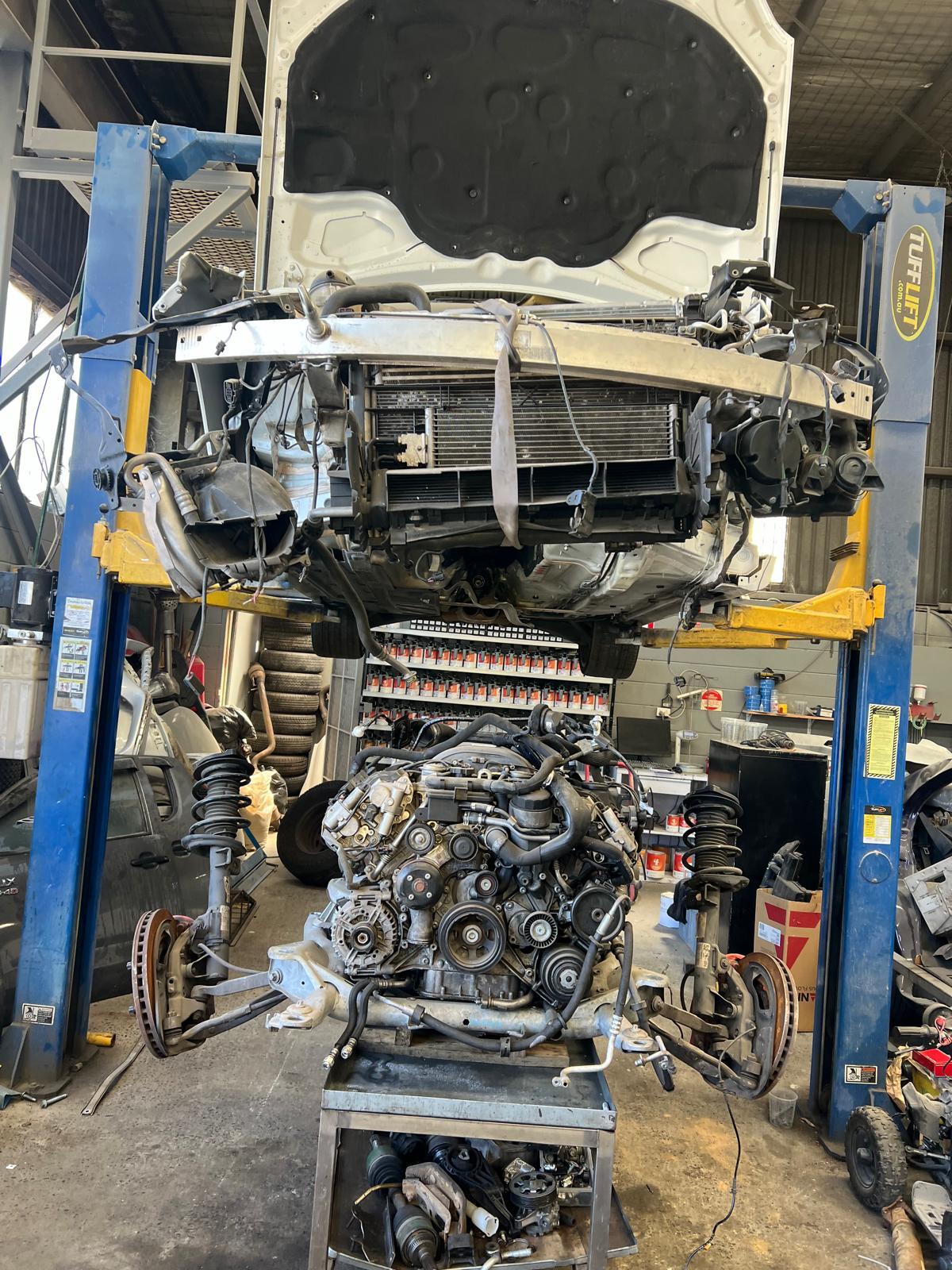 Car on the hoist with its engine and front subframe dropped out